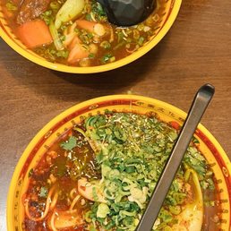 hot & spicy soup (bottom bowl), Tomato Beef Brisket Noodle Soup (top bowl)