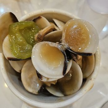 Number 1 Buffet - Manila clams - A close-up of a cup containing cooked Manila clams, some open and some partially open, with a piece of green pepper on top, likely served as seafood at a restaurant. - Buffets Near Me - Avondale, Arizona