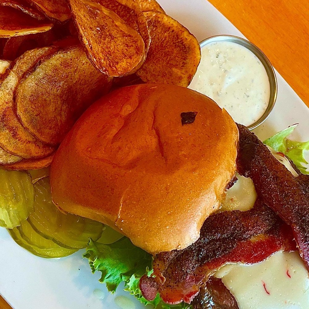 Tribeca Tavern - Wolfpack Burger with BBQ Sauce, Peppered Bacon & Cheese paired with a side of house made chips. - American Near Me - Cary, North Carolina