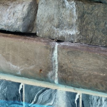 Clean N Blue Pool Solutions - Rusting and white spillage under rock wall less than one month post job - Pool Cleaners Near Me Clean N Blue Pool Solutions - Rusting and white spillage under rock wall less than one month post job - Pool Cleaners Near Me