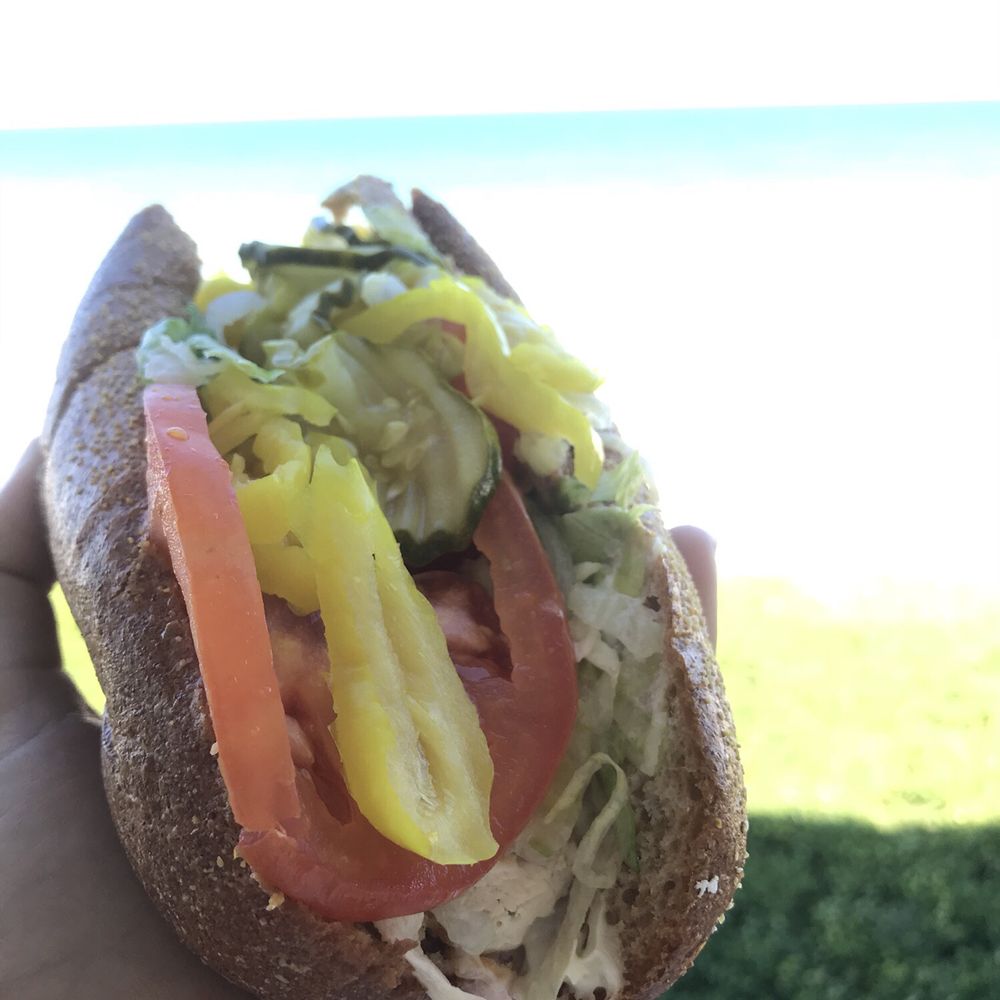 Publix - a hand holding a sandwich with pickles and tomatoes - Grocery Near Me - Satellite Beach, Florida Publix - a hand holding a sandwich with pickles and tomatoes - Grocery Near Me - Satellite Beach, Florida