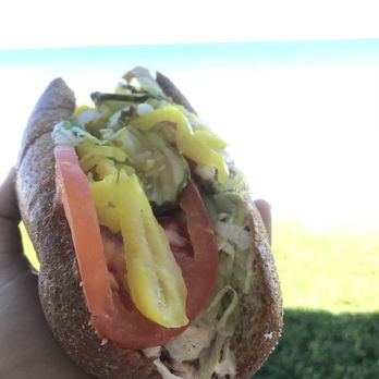 Publix - a hand holding a sandwich with pickles and tomatoes - Grocery Near Me - Satellite Beach, Florida Publix - a hand holding a sandwich with pickles and tomatoes - Grocery Near Me - Satellite Beach, Florida