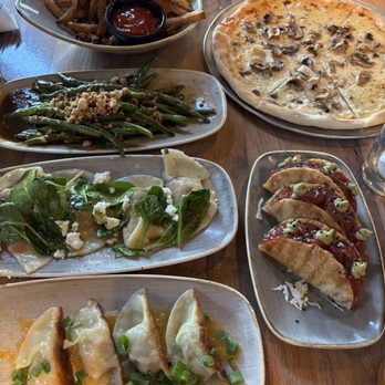 Moku Kitchen - Left: Garlic truffle oil fries, Macadamia nut green beans, Squash ravioli, Pork potstickers Right: White mushroom pizza & Poke tacos - Cocktail Bars Near Me - Honolulu, Hawaii Moku Kitchen - Left: Garlic truffle oil fries, Macadamia nut green beans, Squash ravioli, Pork potstickers Right: White mushroom pizza & Poke tacos - Cocktail Bars Near Me - Honolulu, Hawaii