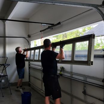 Ohana Garage Door - Putting in the last panel with windows - Garage Door Services Near Me - Katy, Texas Ohana Garage Door - Putting in the last panel with windows - Garage Door Services Near Me - Katy, Texas
