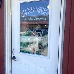 Pease Cafe - Entrance to Pease Cafe but with owner in the window.