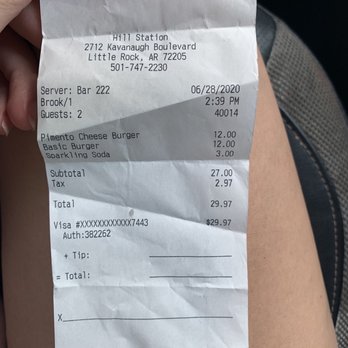 Hill Station - a person holding a receipt in their hand - Bars Near Me - Little Rock, Arkansas