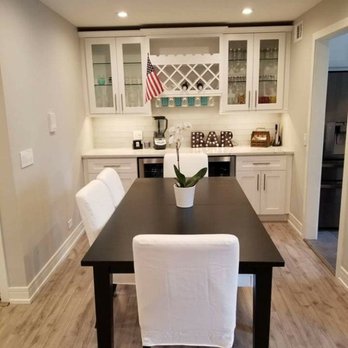 Pro Reconstruction Experts - a dining room with a black table and white chairs - General Contractors Near Me - Schaumburg, Illinois Pro Reconstruction Experts - a dining room with a black table and white chairs - General Contractors Near Me - Schaumburg, Illinois