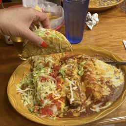 Hard taco, tamale, smothered enchiladas, refried beans & melted cheese Hard taco, tamale, smothered enchiladas, refried beans & melted cheese