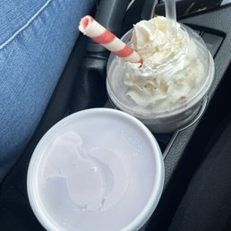 a cup of ice cream and a candy cane a cup of ice cream and a candy cane