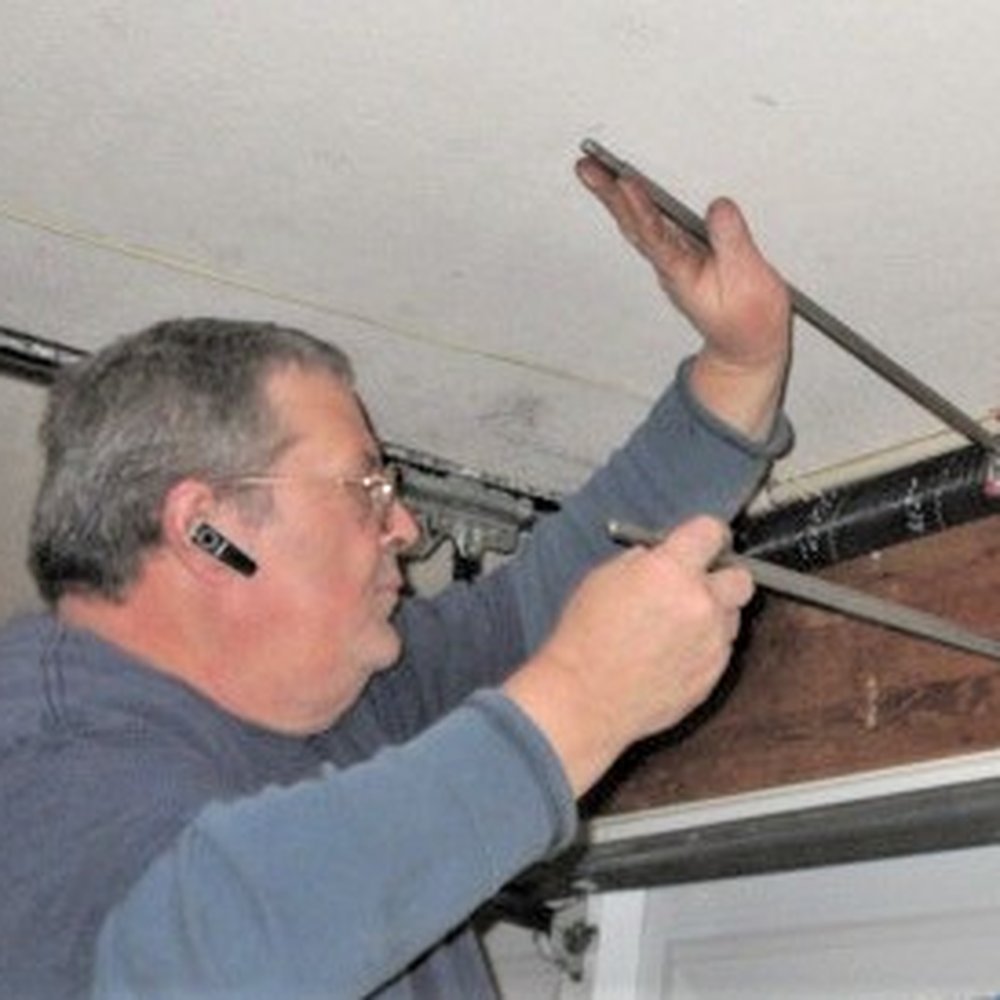 Automatic Garage Door Services - Tightening the new springs into place. - Garage Door Services Near Me - Lancaster, California