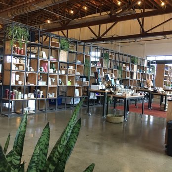 Paddywax Candle Bar - I'm digging the design choices here. Lots of green plants, leather goods, and tons of candles for sale! - Gift Shops Near Me - Nashville, Tennessee