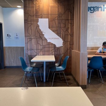 McDonald's - a man sitting at a table - Burgers Near Me - Morgan Hill, California