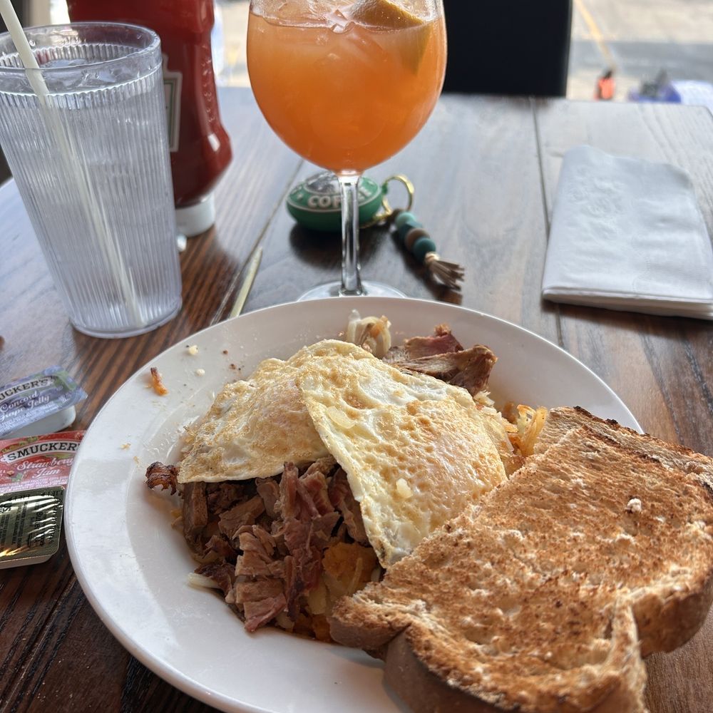 Blue Note - Breakfast hash with passion fruit mimosa - Sports Bars Near Me - St. Louis, Missouri