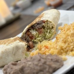 Burrito de Cecina with a side of dinner rice and beans