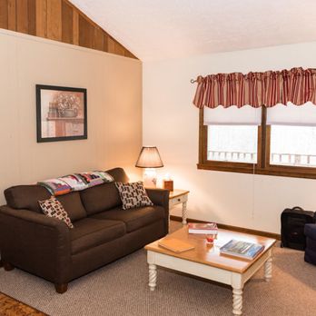 The Retreat at Crabtree Falls - The living space is open with a sofa, sofa chair, coffee table, side table and TV with a DVD Player - Vacation Rentals Near Me - Tyro, Virginia The Retreat at Crabtree Falls - The living space is open with a sofa, sofa chair, coffee table, side table and TV with a DVD Player - Vacation Rentals Near Me - Tyro, Virginia
