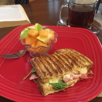 The Coffee Studio - a red plate with a sandwich and a bowl of fruit - Cafes Near Me - Stevens Point, Wisconsin