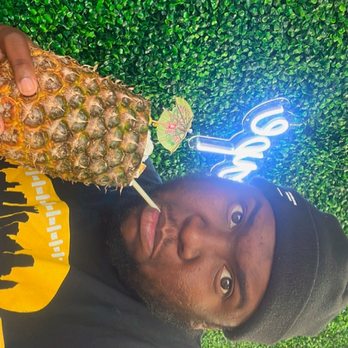 Sweet Block - a man holding a pineapple - Desserts Near Me - Silver Spring, Maryland