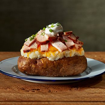 True Texas BBQ - a baked potato topped with bacon and cheese - Barbeque Near Me - Plano, Texas True Texas BBQ - a baked potato topped with bacon and cheese - Barbeque Near Me - Plano, Texas