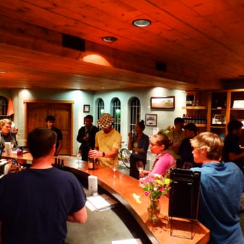 Forgeron Cellars - a group of people standing around a bar - Wineries Near Me - Walla Walla, Washington