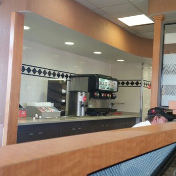 Arby's - a man sitting at a counter in a restaurant - Fast Food Near Me - Sedalia, Missouri