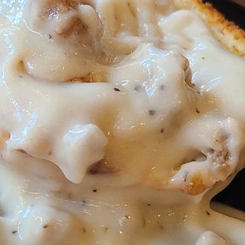 Nana's Caffe - Biscuits and Gravy - A detailed close-up of biscuits topped with creamy gravy, served on a plate at Nana's Caffe in Coburg, OR. - Breakfast & Brunch Near Me - Coburg, Oregon