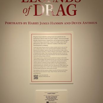 MOWA - St Kate - The image shows an exhibition poster titled 'Legends of Drag,' featuring portraits by Harry James Hanson and Devin Antheus. The poster includes a detailed description of the exhibition, its themes, and the artists involved. It also contains a QR code and acknowledgments for sponsors and supporters. The poster is mounted on a plain wall and is primarily text-based with a simple, professional layout. - Art Galleries Near Me - Milwaukee, Wisconsin