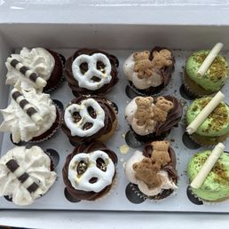 Mini cupcake assortment: red velvet, white & black; s'more, and pistachio.