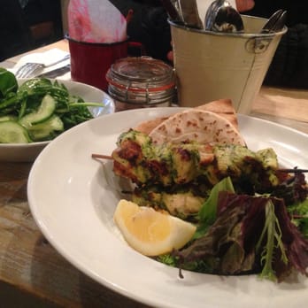 Bill's - Chicken skewers served with couscous and pita bread - Modern European Near Me - London, XGL Bill's - Chicken skewers served with couscous and pita bread - Modern European Near Me - London, XGL