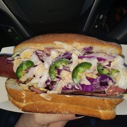 a hot dog with coleslaw and jalapenos