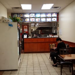 a woman sitting at a table in a restaurant