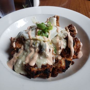 Dirty Oscar's Annex - The Colonel ( chicken fried bites, sausage gravy, bacon egg over easy and sriracha mayo and green onions) - Pubs Near Me - Tacoma, Washington Dirty Oscar's Annex - The Colonel ( chicken fried bites, sausage gravy, bacon egg over easy and sriracha mayo and green onions) - Pubs Near Me - Tacoma, Washington