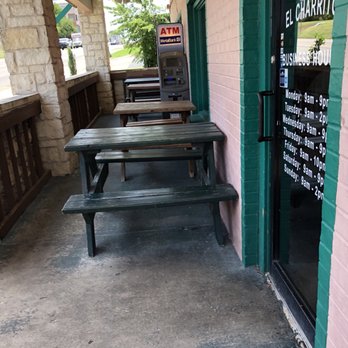 El Charrito - Entrance, hours on door & outdoor dining area - Mexican Near Me - Georgetown, Texas