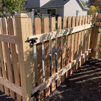 Red Cedar Fence - Closer look at the removable fence segment in front of the utility box, held in place with four slide bolts. - Fences & Gates Near Me - Wheeling, Illinois
