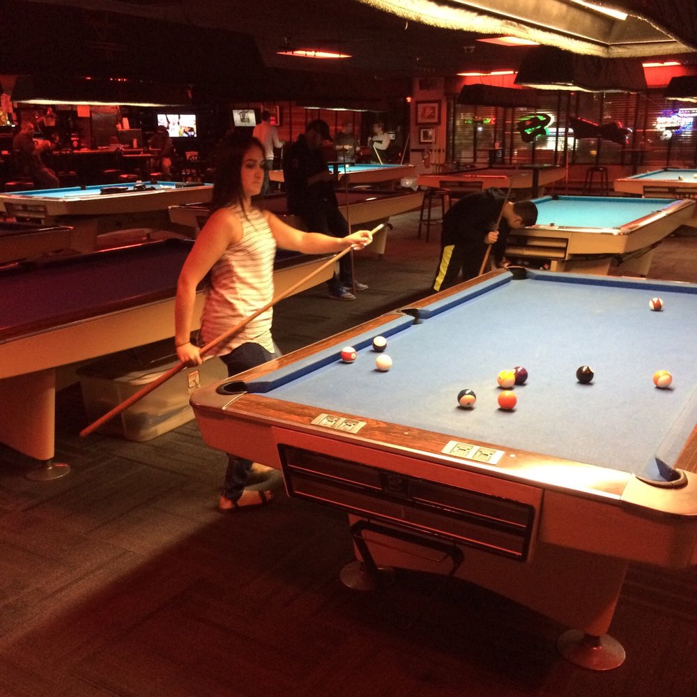 a woman playing pool a woman playing pool