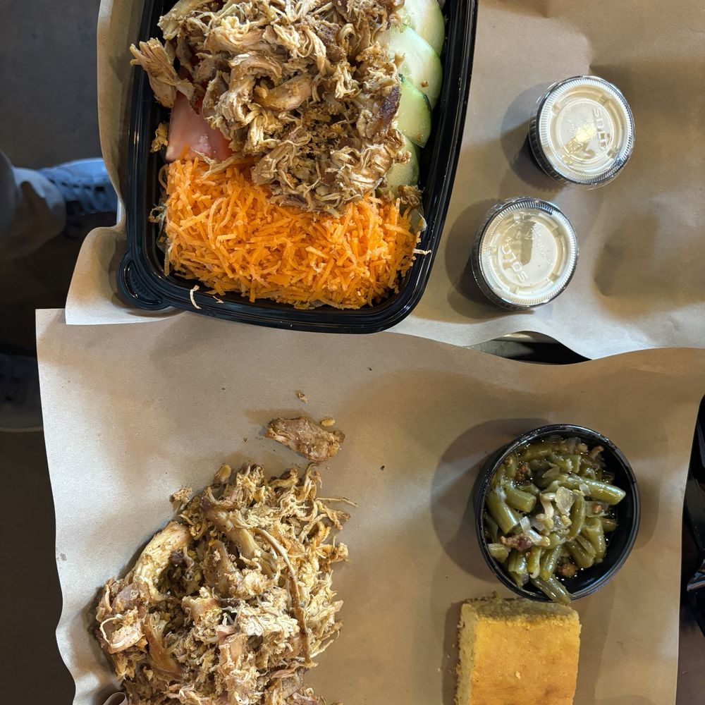 Garden salad with pulled chicken and pulled chicken entree and greens and beans.