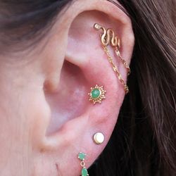 HTC Studios - Phoenix Uptown - Fresh ear curation. Helix, conch, and earlobe piercings wearing yellow gold and chrysoprase jewelry from BVLA