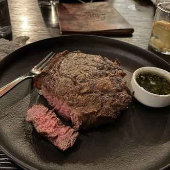 Cut & Bourbon - Perfectly cooked medium ribeye w/chimichuri sauce - Steakhouses Near Me - Arlington, Texas