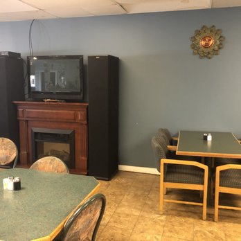 Mamenche's - a dining room with a television and fireplace - Salvadoran Near Me - Edmonton, Alberta Mamenche's - a dining room with a television and fireplace - Salvadoran Near Me - Edmonton, Alberta