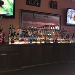 a bar full of liquor bottles a bar full of liquor bottles