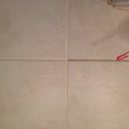 Applying bone-colored grout stain.  (dirty old grout on right, newly applied still-wet stain on left)