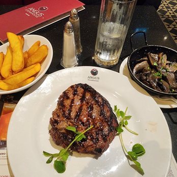 Angus Steak House - 12oz Ribeye with Chunky Chips and Mushrooms - British Near Me - London, XGL Angus Steak House - 12oz Ribeye with Chunky Chips and Mushrooms - British Near Me - London, XGL