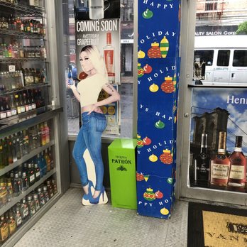 WK Wines And Liquors - a woman holding a sign - Beer, Wine & Spirits Near Me - Brooklyn, New York