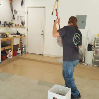 Concrete By Design - a man using a pole to paint a room - Flooring Near Me - Austin, Texas Concrete By Design - a man using a pole to paint a room - Flooring Near Me - Austin, Texas