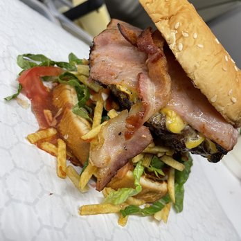 Avila Grill - a sandwich with meat, lettuce, and french fries - Food Trucks Near Me - Miami, Florida