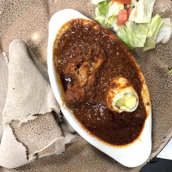 Habesha Market & Carry-out - Doro Wot. Traditional dish, chicken stew simmered in berbere sauce and herbal butter served with injera.