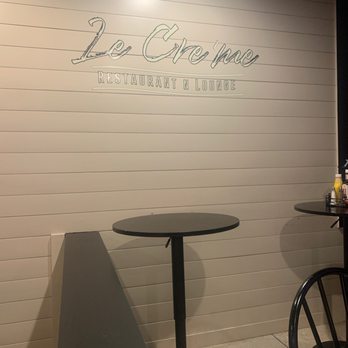 Le Creme - a table and chairs in a restaurant - American Near Me - Charleston, South Carolina