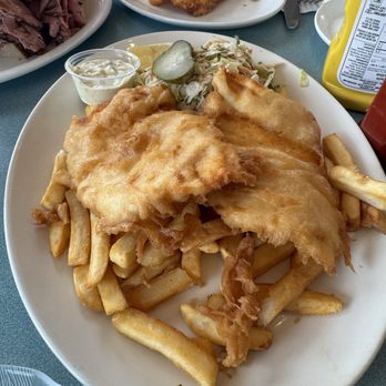 Peter's On Eglinton - 2 piece Fish and chips with an extra fish in the background. - Fish & Chips Near Me - Mississauga, Ontario Peter's On Eglinton - 2 piece Fish and chips with an extra fish in the background. - Fish & Chips Near Me - Mississauga, Ontario