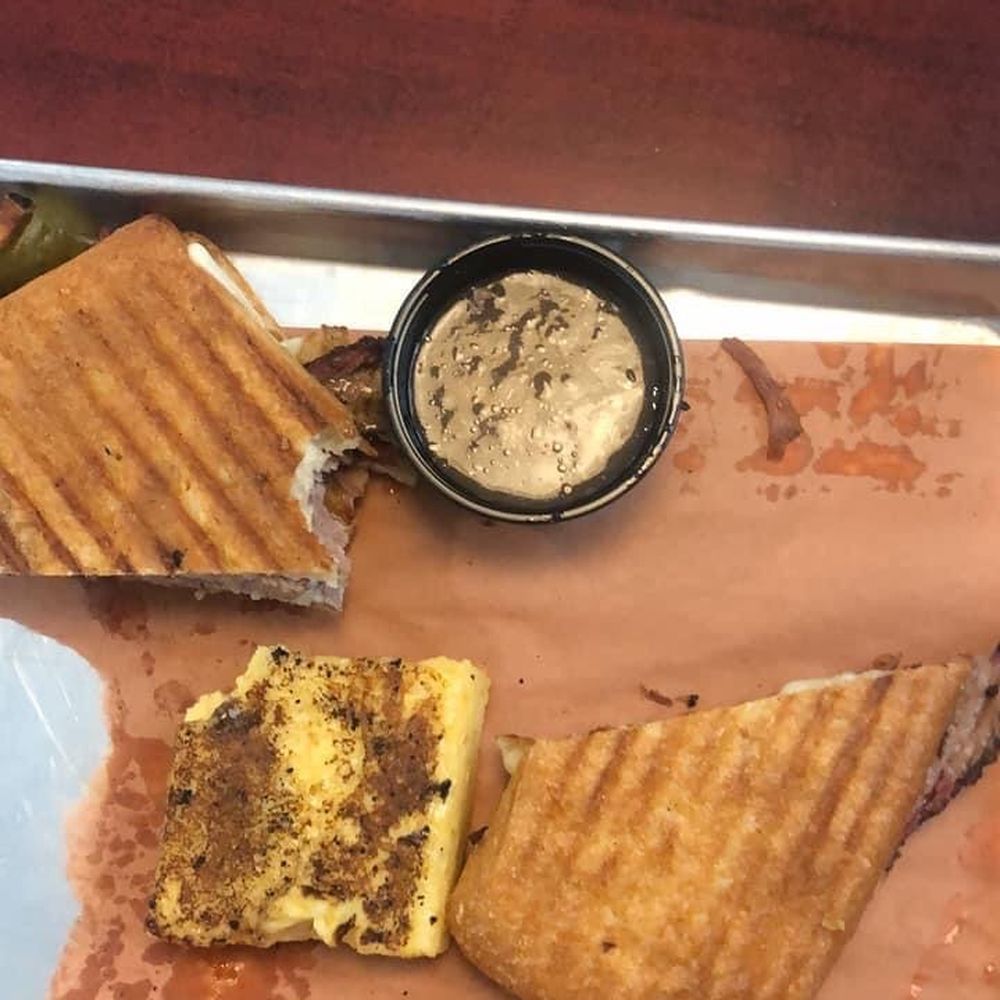 Two Drummers Smokehouse - Certified Angus Beef ® Brisket French Dip with a side of Cheddar Grit Cake - Barbeque Near Me - Toano, Virginia Two Drummers Smokehouse - Certified Angus Beef ® Brisket French Dip with a side of Cheddar Grit Cake - Barbeque Near Me - Toano, Virginia