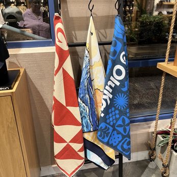 OluKai - Beach towels. Love the yellow one in the middle which is a sunset. They seem to be sand repellent. - Shoe Stores Near Me - Lake Buena Vista, Florida OluKai - Beach towels. Love the yellow one in the middle which is a sunset. They seem to be sand repellent. - Shoe Stores Near Me - Lake Buena Vista, Florida