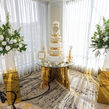 Cake Studio La - a wedding cake and vases of flowers - Bakeries Near Me Cake Studio La - a wedding cake and vases of flowers - Bakeries Near Me